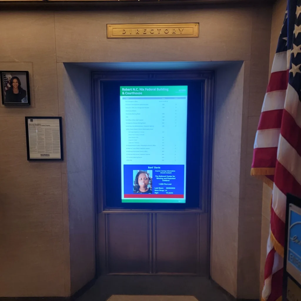 Vertical digital building directory mounted in alcove in lobby of Robert C. Nix Federal Building and Courthouse in Philadelphia, Pennsylvania.