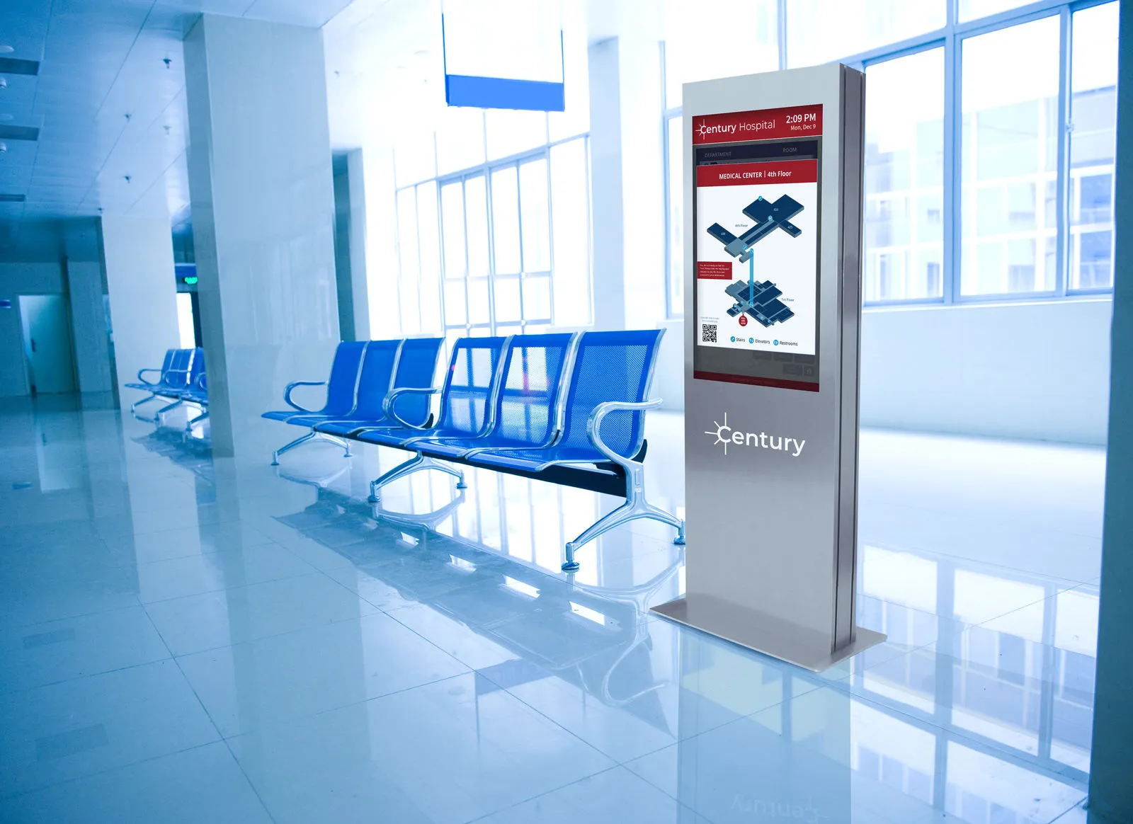 Stainless steel interactive kiosk that says "Century" on enclosure in a hospital lobby showing hospitals wayfinding with contactless self-service.