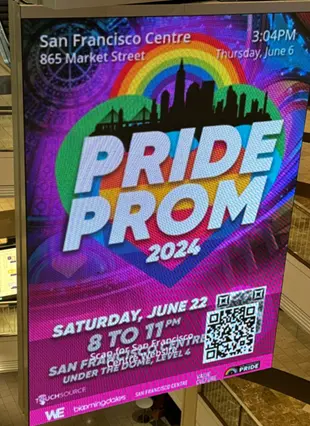 Colorful rainbow themed LED video wall display advertising "Pride Prom 2024' at San Francisco Mall.