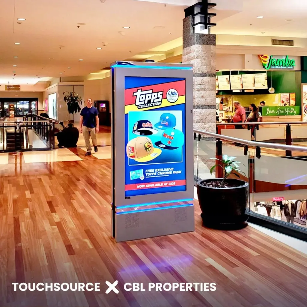 bright mall digital kiosk featuring advertisement on wooden floor on second story of indoor mall.