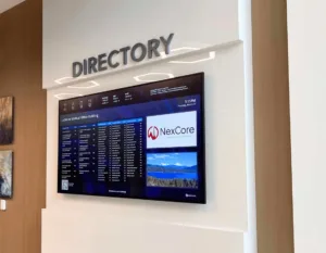 wall-mounted black digital directory in a medical office building showing providers, doctors, and images.