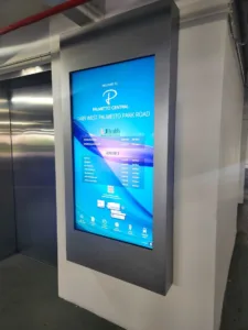 Digital directory screen in a wall panel showing directions to Palmetto Central, 1489 West Palmetto Park Road.